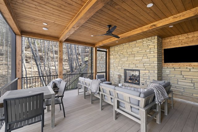 Carriage House Charmer screened porch with outdoor fireplace